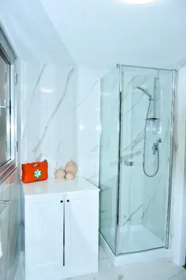 a bathroom with a glass shower with a counter at Appartamento Piazza del parlamento 3 in Rome