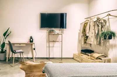 a bedroom with a bed and a desk and a tv at Santa Nara B&B in Rome