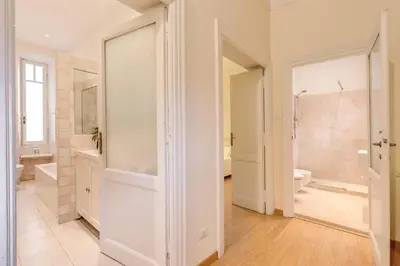 a white bathroom with a tub and a toilet and a sink at RHH Rome Holiday Home in Rome
