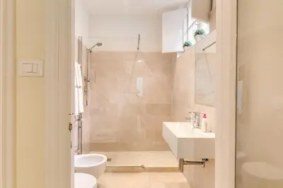 a bathroom with a toilet and a sink and a shower at RHH Rome Holiday Home in Rome