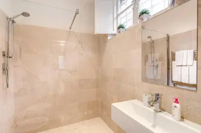 a bathroom with a sink and a shower at RHH Rome Holiday Home in Rome