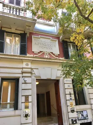 a building with a sign on the front of it at RHH Rome Holiday Home in Rome