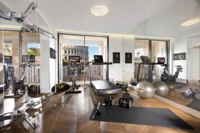 a gym with exercise equipment and a view of the city at Hotel Palazzo Manfredi – Small Luxury Hotels of the World in Rome