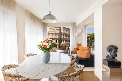 a living room with a table with a vase of flowers at Hotel Palazzo Manfredi – Small Luxury Hotels of the World in Rome