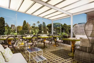 a restaurant with tables and chairs and large windows at Hotel Palazzo Manfredi – Small Luxury Hotels of the World in Rome
