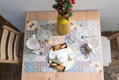 a table with plates and cups and a vase on it at STELLA'S APARTMENT IN MONTI in Rome