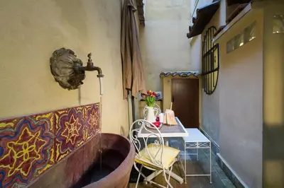 a room with a bathtub and a table with a chair at STELLA'S APARTMENT IN MONTI in Rome