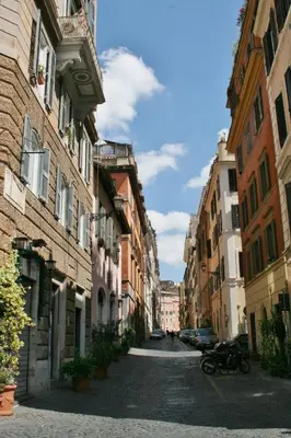 an empty street in an alley with buildings at STELLA'S APARTMENT IN MONTI in Rome