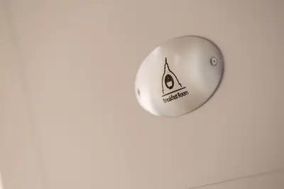 a white ball with a pizza sign on a wall at Vatican Relais Rome Suite in Rome