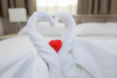 a pair of swans forming a heart on a bed at Vatican Relais Rome Suite in Rome