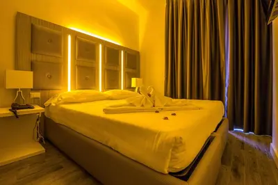a bedroom with a large white bed in a room at Vatican Relais Rome Suite in Rome
