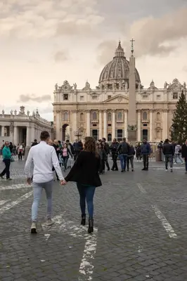 a man and woman walking in front of a building at Vatican Relais Rome Suite in Rome
