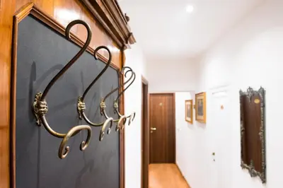 a hallway with a door with hooks on it at Domus Popolo in Rome