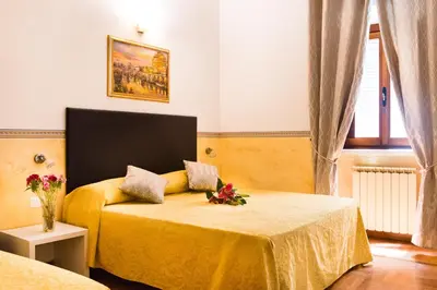 a bedroom with two beds with flowers on it at Domus Popolo in Rome
