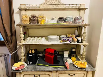 a shelf with a coffee maker and plates on it at Domus Popolo in Rome