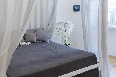a bedroom with a bed with a canopy at Relais Dolcevita in Rome