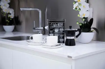 a kitchen counter with two cups and a coffee maker at Relais Dolcevita in Rome
