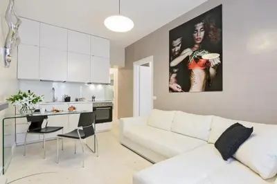 a living room with a white couch and a table at Petra Apartments in Rome