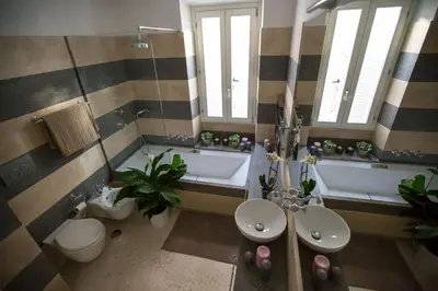 a bathroom with a tub and a toilet and a sink at Petra Apartments in Rome