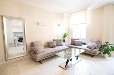 a living room with a couch and a table and a mirror at Petra Apartments in Rome