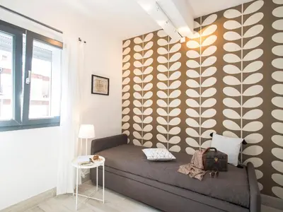 a bedroom with a bed and a yellow wall at SkyTower in Rome