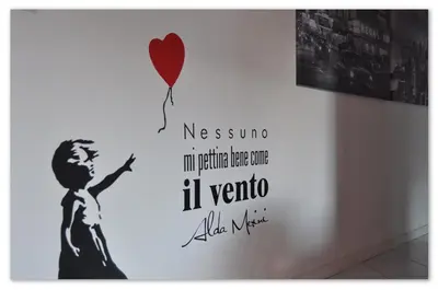 a wall with a sticker of a boy with a balloon at Valentina Vatican Apartment in Rome
