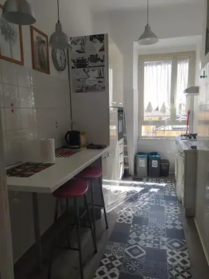 a kitchen with a counter and stools in a room at Valentina Vatican Apartment in Rome