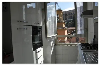 a kitchen with a view of a city from a window at Valentina Vatican Apartment in Rome