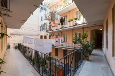 an alley in an apartment building with clotheslines at San Cosimato House in Rome
