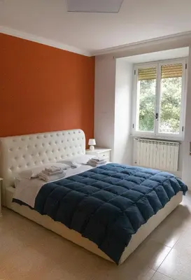 a bedroom with a large bed with a blue blanket at Flaminio New Apartment in Rome