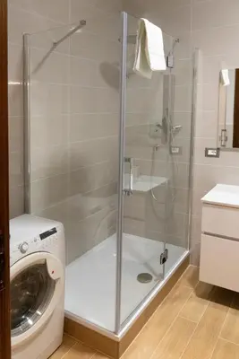 a shower in a bathroom with a washing machine at Flaminio New Apartment in Rome
