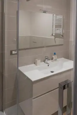 a bathroom with a sink and a shower at Flaminio New Apartment in Rome