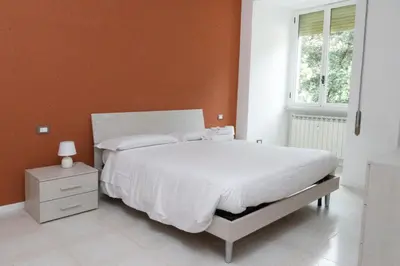 a bedroom with a white bed and a window at Flaminio New Apartment in Rome