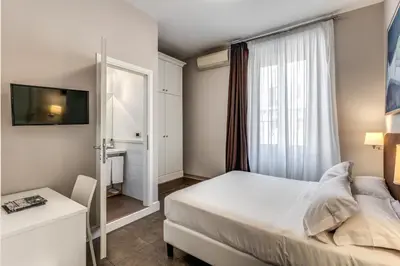 a hotel room with a bed and a window at Guest House Cavour 278 in Rome