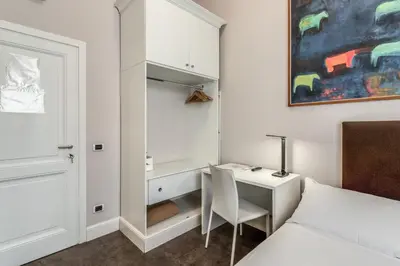 a bedroom with a desk and a bed and a desk at Guest House Cavour 278 in Rome