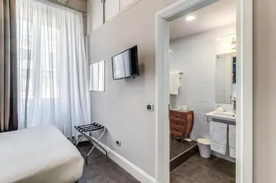 a hotel room with a bed and a sink at Guest House Cavour 278 in Rome