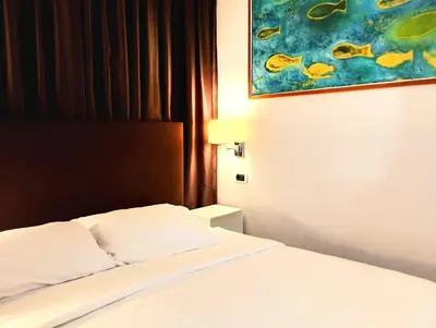a bed in a hotel room with a painting on the wall at Guest House Cavour 278 in Rome