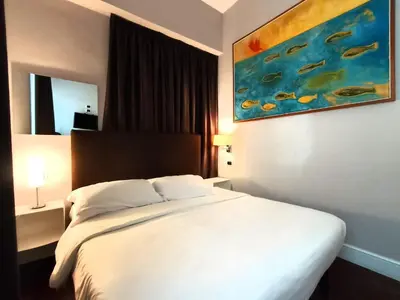 a bedroom with a white bed and a painting on the wall at Guest House Cavour 278 in Rome