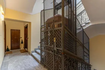 a staircase in a house with a wrought iron gate at Guest House Cavour 278 in Rome
