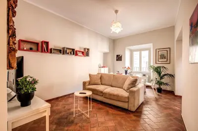 a living room with a couch and a table at Appartamenti - Via del Monte della Farina in Rome