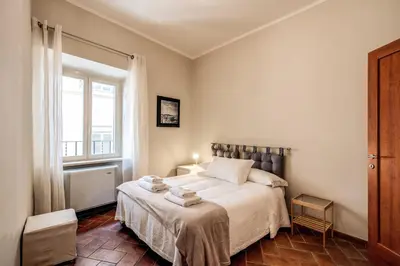 a bedroom with a bed and a window at Appartamenti - Via del Monte della Farina in Rome