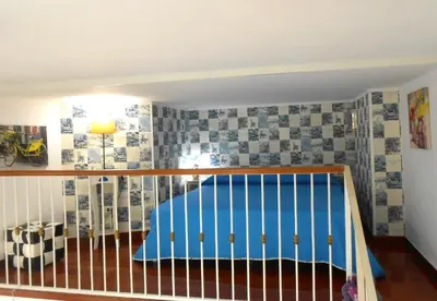a childs room with a crib with blue and white tiles at La casetta di Josephine in Rome