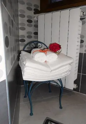a bench with two towels and a flower on it at La casetta di Josephine in Rome