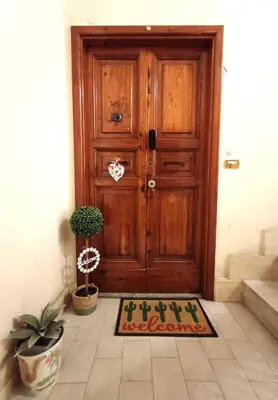 a wooden door with a mat in front of it at La casetta di Josephine in Rome