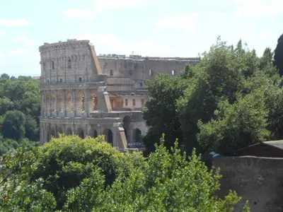 an old building in the distance with trees in the foreground at La casetta di Josephine in Rome