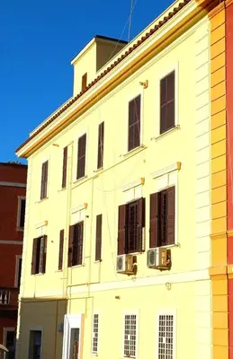 a white building with black shutters on it at La casetta di Josephine in Rome