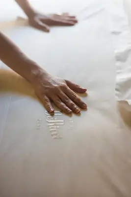 a hand on a bed with the words i love you written on it at Hotel De' Ricci - Small Luxury Hotels of the World in Rome