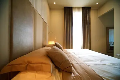 a large bed in a room with a window at BeSecret Vittoriano - Vittoriano Luxury Suites in Rome