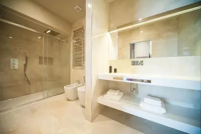 a bathroom with a shower and a toilet and a sink at BeSecret Vittoriano - Vittoriano Luxury Suites in Rome