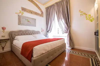 a bedroom with a bed and a large window at Trastevere Royal Suite in Rome